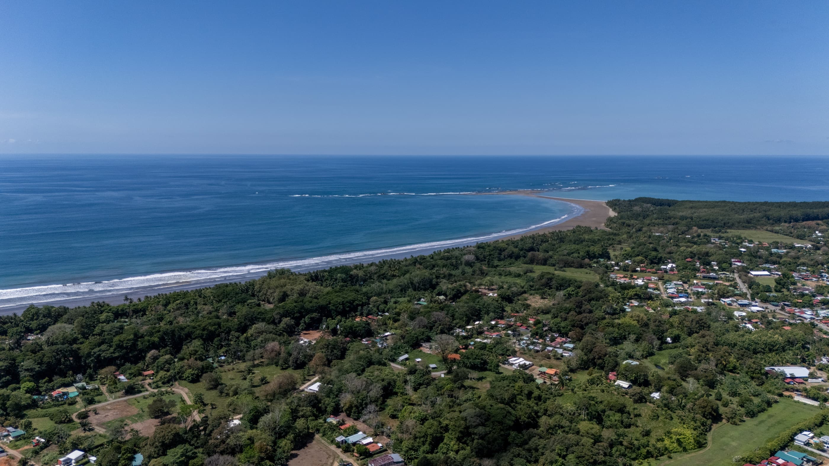 The Whale's Tail sandbar curving into Bahía Ballena, seen from the air above Uvita on Costa Rica's South Pacific coast